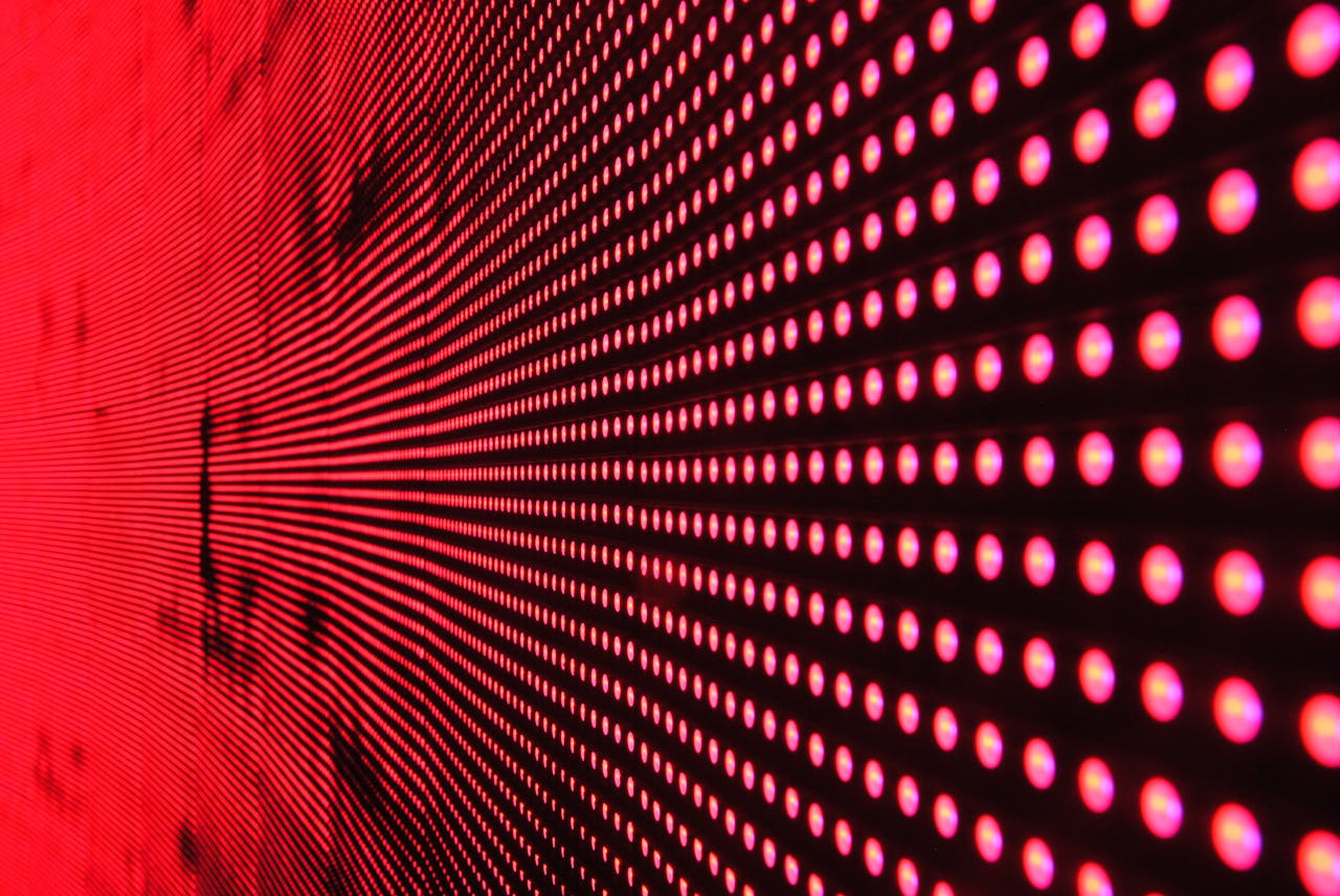 services-02 Vibrant abstract pattern of illuminated red LED lights forming a dynamic design.