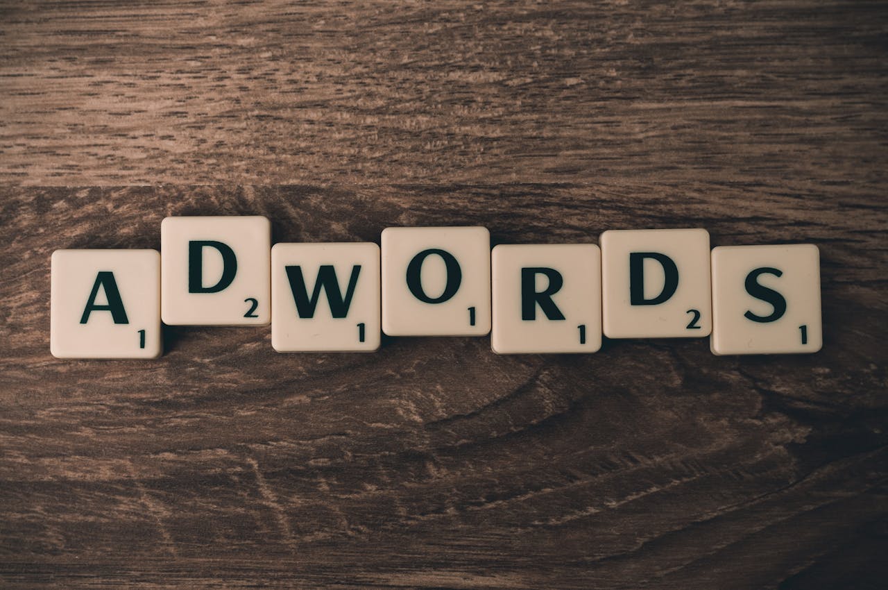 services-03 Scrabble tiles spelling AdWords on a wooden surface, symbolizing digital marketing concepts.